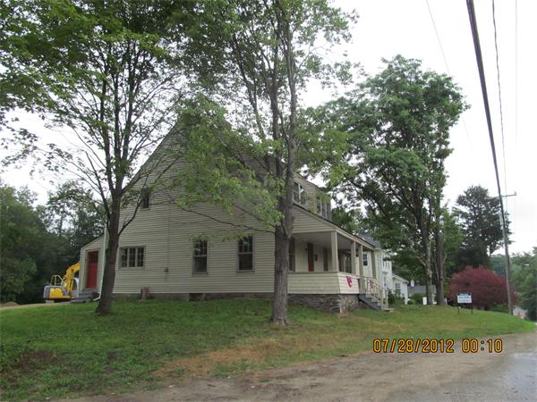 1574 Main Road Granville, MA 01034 - Photo 3 of 13 a front view of a house with a garden