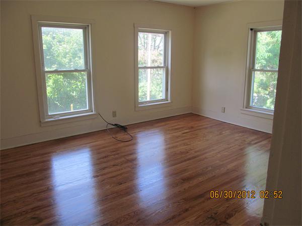 1574 Main Road Granville, MA 01034 - Photo 9 of 13 a view of an empty room with wooden floor and a window