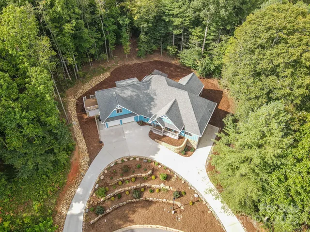 a large kitchen with kitchen island a large counter top space a sink stainless steel appliances and cabinets