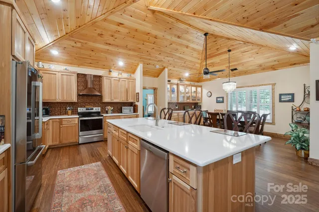 a kitchen with granite countertop a stove sink and cabinets