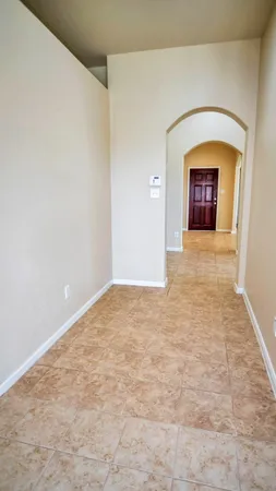 a view of a hallway with a wooden door