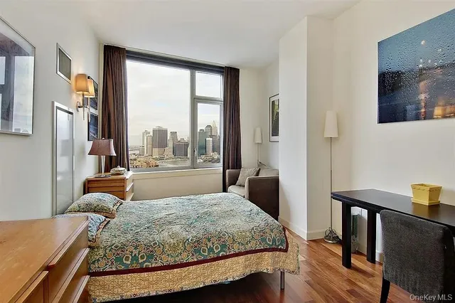 a bedroom with a large bed and a large window