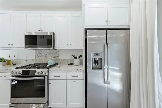 a kitchen with sink stove and cabinets
