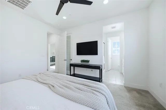 a bedroom with bed and a ceiling fan