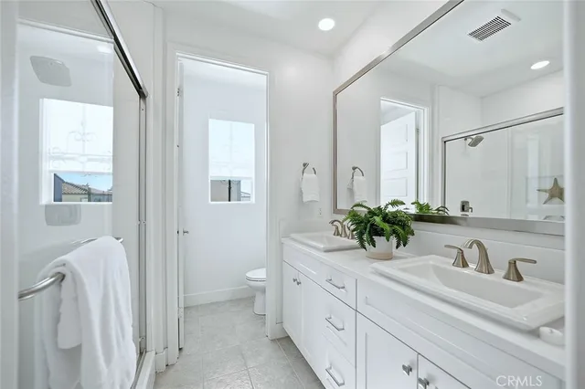 a bathroom with a double vanity sink and mirror