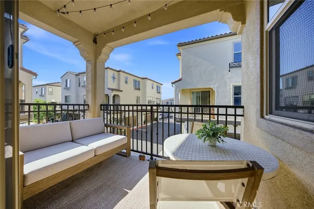 a balcony with table and chairs