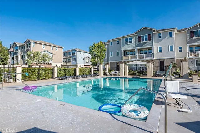 a swimming pool view with a outdoor seating