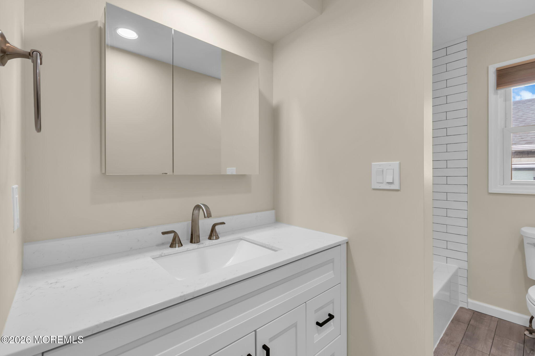 404 9th Avenue, Unit UPPR Belmar, NJ 07719 - Photo 21 of 29 a bathroom with a sink and a mirror