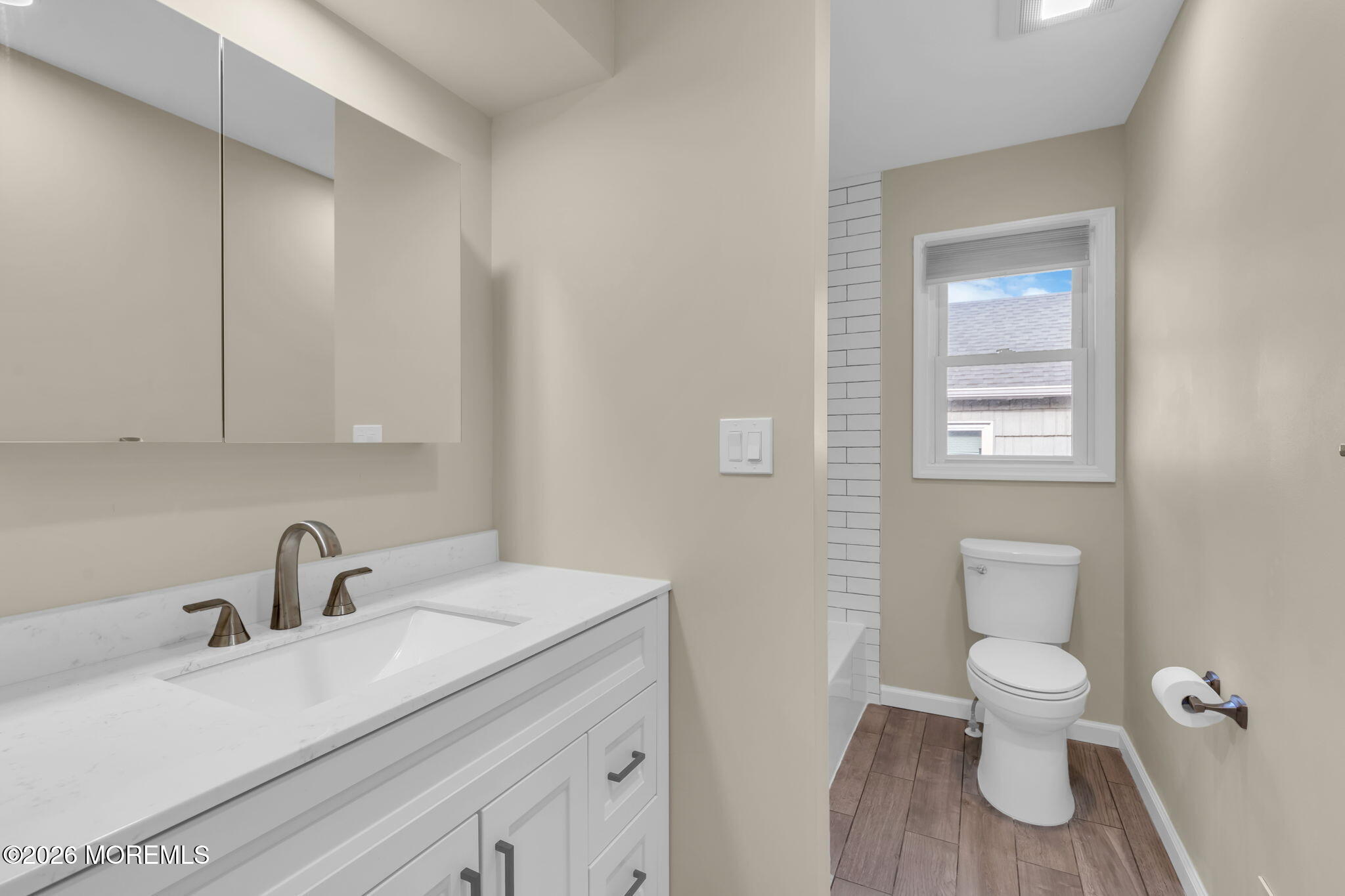 404 9th Avenue, Unit UPPR Belmar, NJ 07719 - Photo 22 of 29 a bathroom with a toilet a sink and mirror