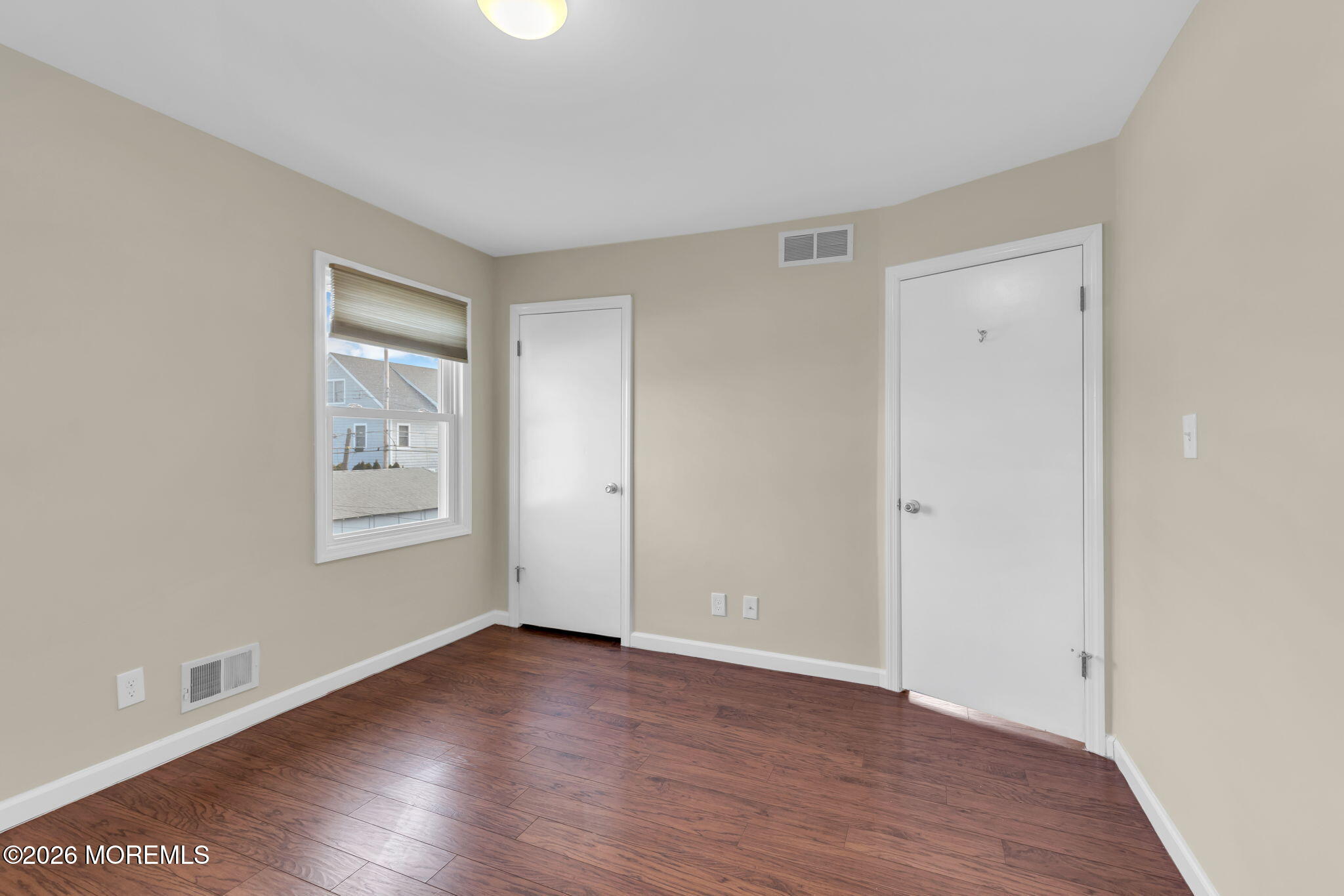 404 9th Avenue, Unit UPPR Belmar, NJ 07719 - Photo 26 of 29 an empty room with wooden floor and windows