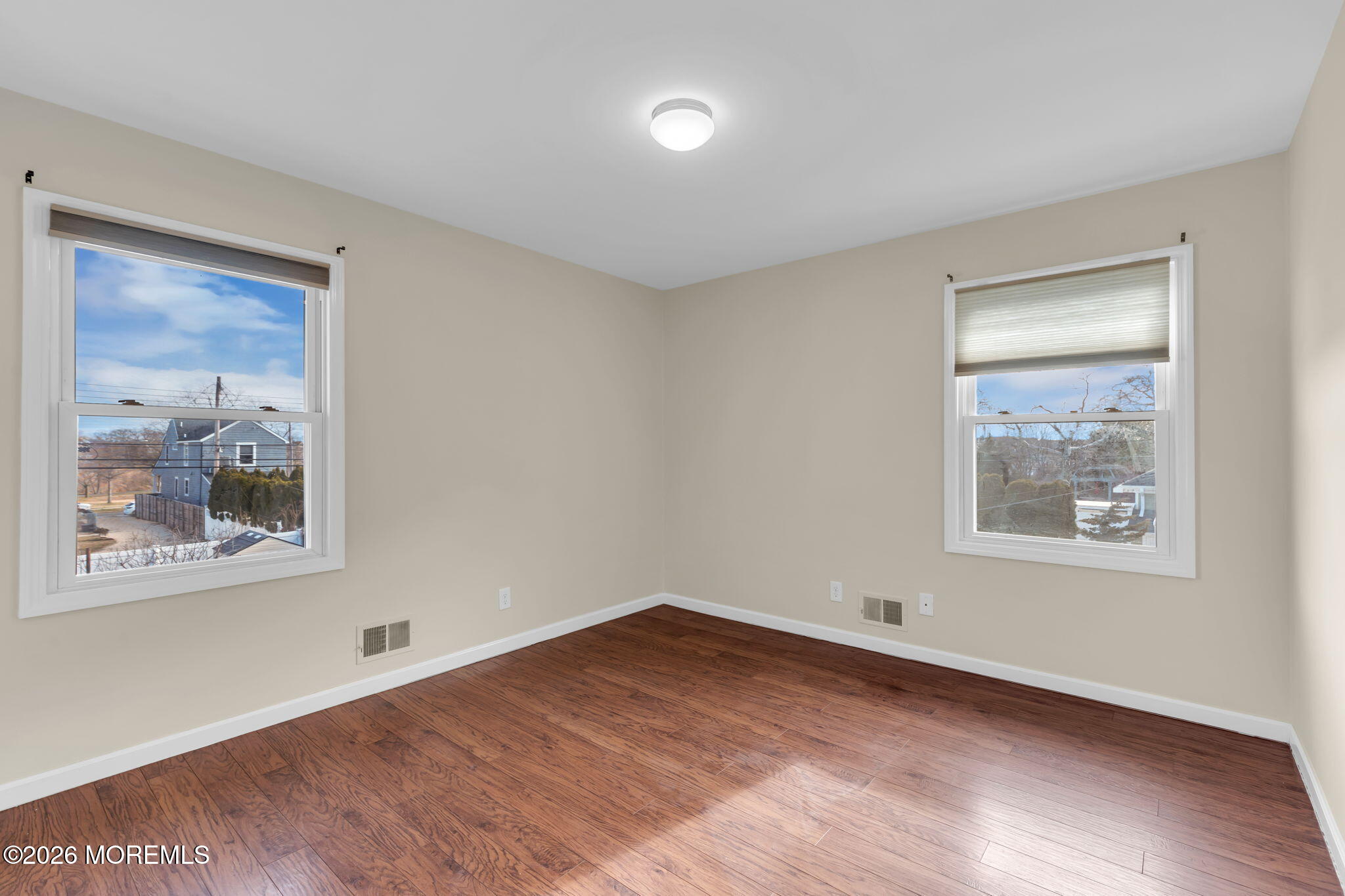 404 9th Avenue, Unit UPPR Belmar, NJ 07719 - Photo 27 of 29 a view of an empty room with wooden floor and a window