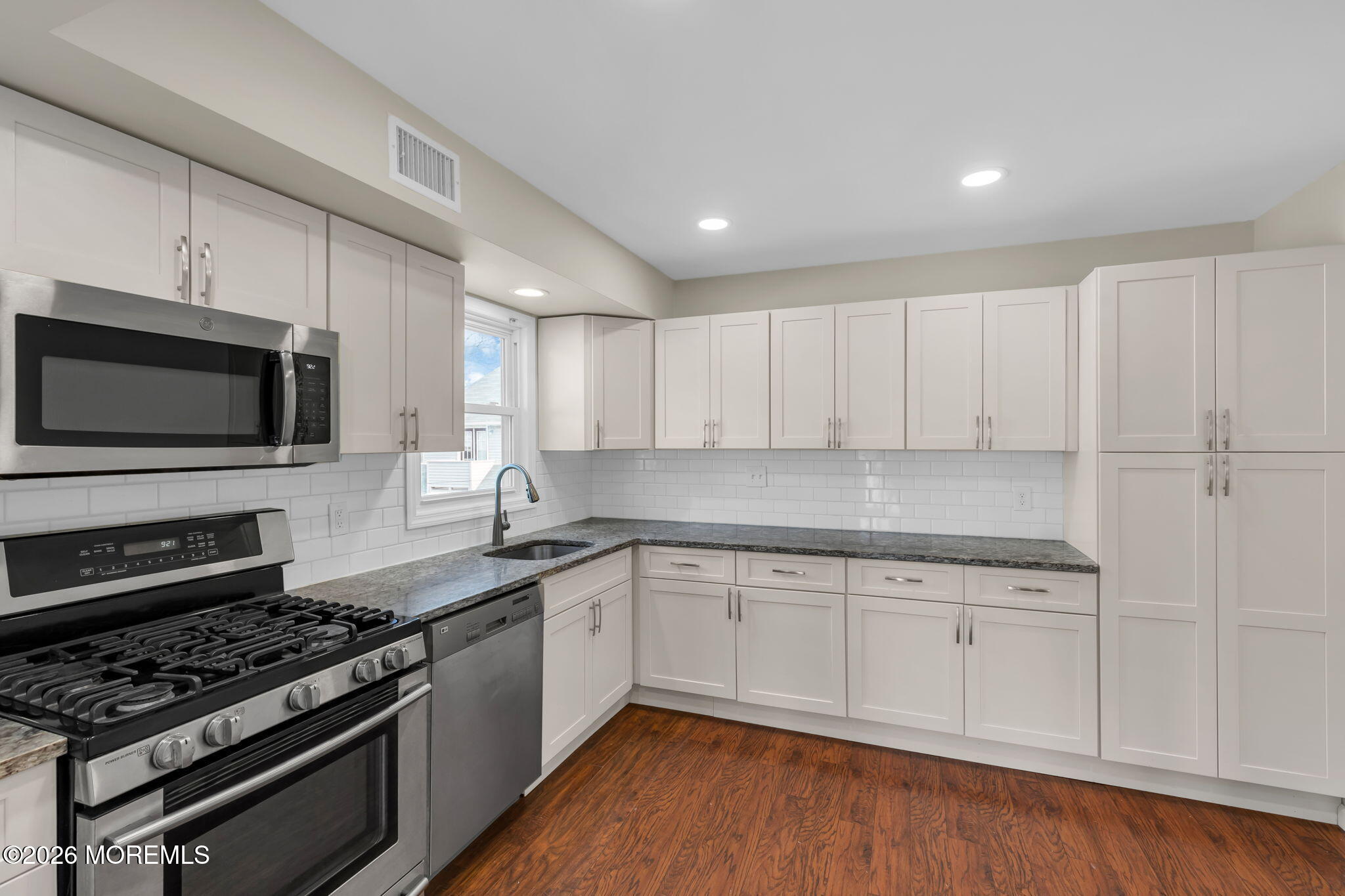 404 9th Avenue, Unit UPPR Belmar, NJ 07719 - Photo 9 of 29 a kitchen with stainless steel appliances granite countertop a stove a sink and a microwave