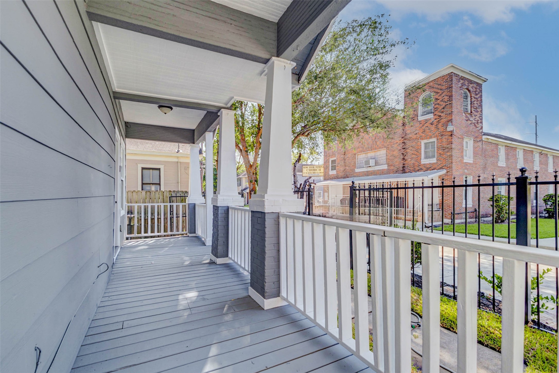 1606 Ruthven Street, Unit AB Houston, TX 77019 - Photo 5 of 6 a view of a porch with wooden floor and fence