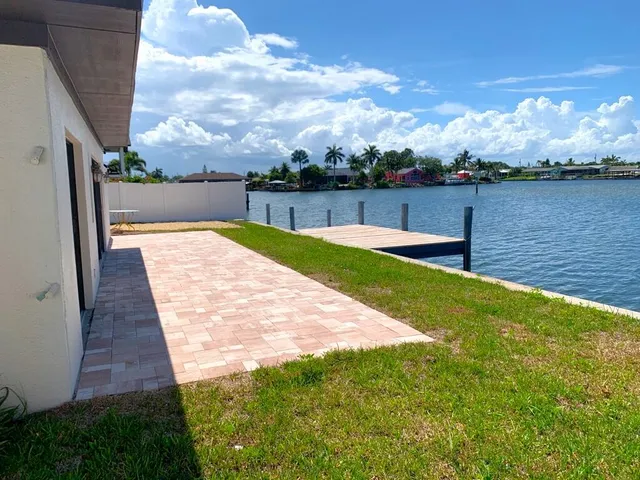 a view of a backyard with sitting area