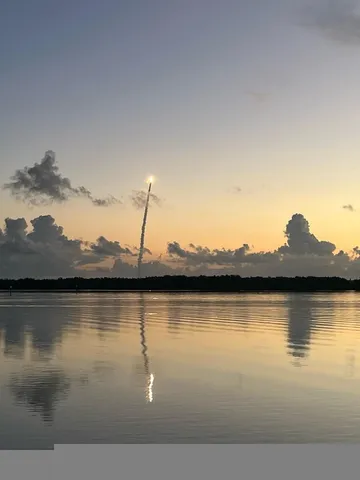 a view of a lake with houses in the back