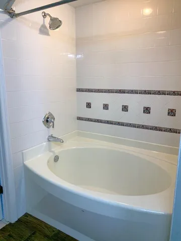 a bathroom with a bathtub and shower