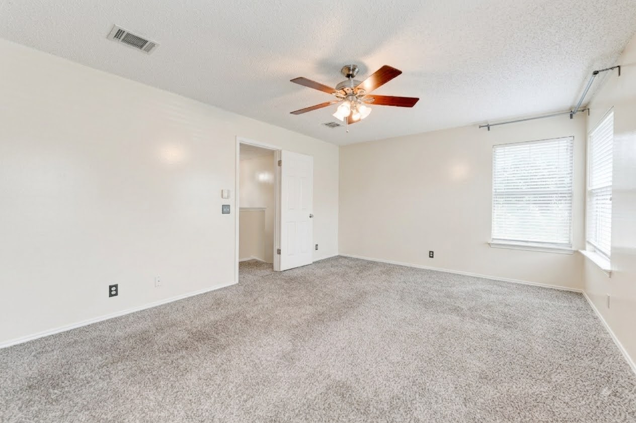 16913 Langland Road Pflugerville, TX 78660 - Photo 8 of 18 Plush wall-to-wall carpeting and multi-directional windows anchor this comfortable, airy bedroom.
