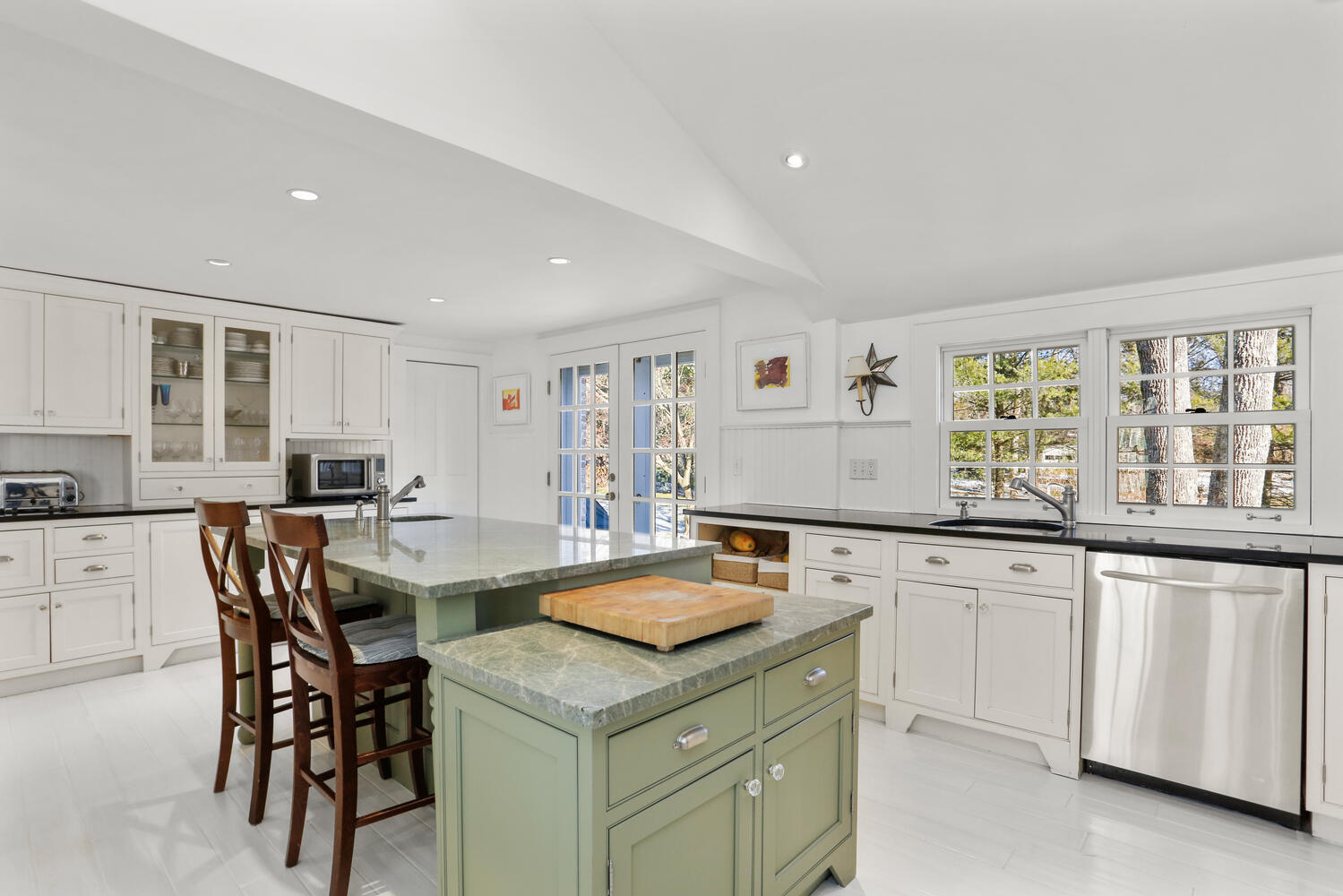 427 Eden Road Stamford, CT 06907 - Photo 5 of 40 a kitchen with sink a center island and chairs