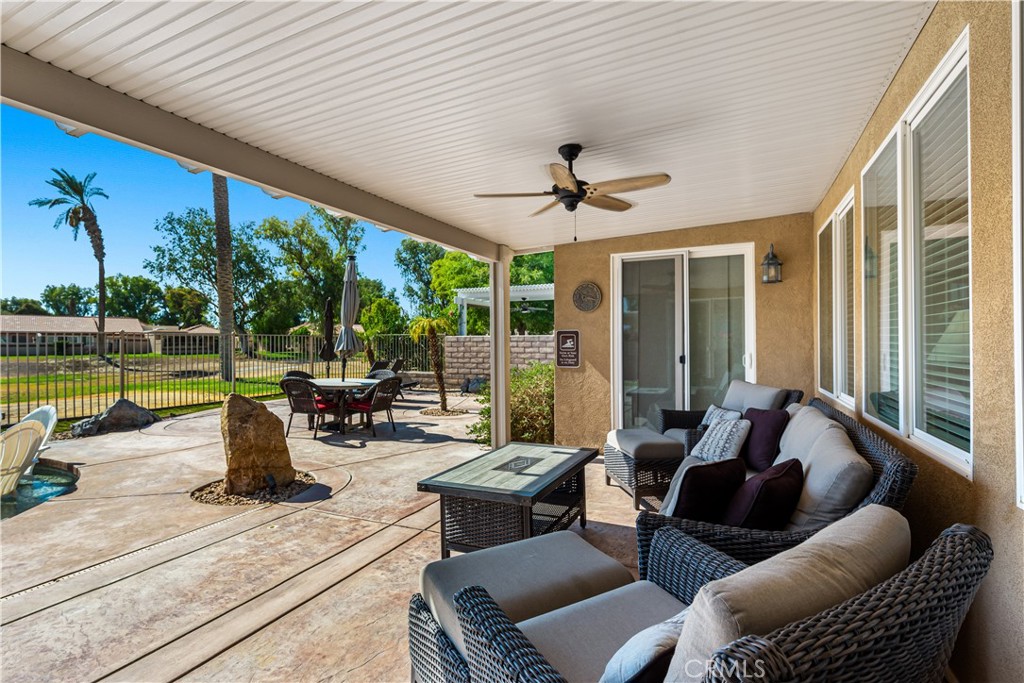 49267 Biery Street Indio, CA 92201 - Photo 12 of 28 a living room with patio furniture and a floor to ceiling window