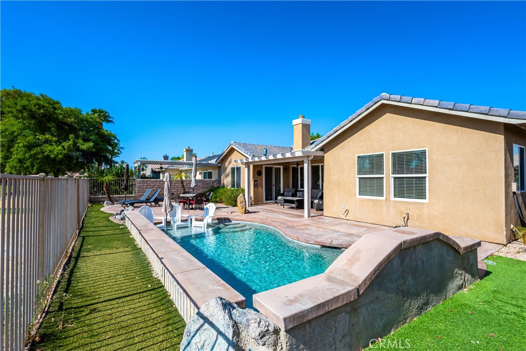 49267 Biery Street Indio, CA 92201 - Photo 16 of 28 a view of house with swimming pool outdoor seating