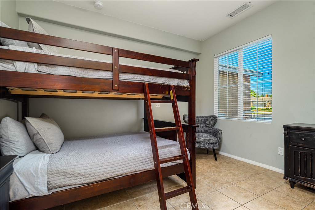 49267 Biery Street Indio, CA 92201 - Photo 19 of 28 a bedroom with a bed and a window