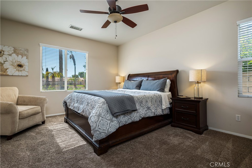 49267 Biery Street Indio, CA 92201 - Photo 25 of 28 a bedroom with a bed couch and window