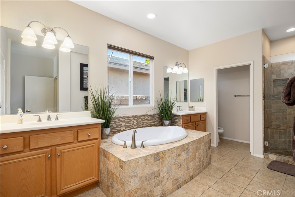 49267 Biery Street Indio, CA 92201 - Photo 27 of 28 a spacious bathroom with a tub sink and mirror