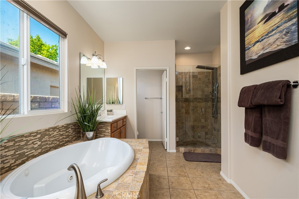 49267 Biery Street Indio, CA 92201 - Photo 28 of 28 a bathroom with a granite countertop tub a sink and a large mirror