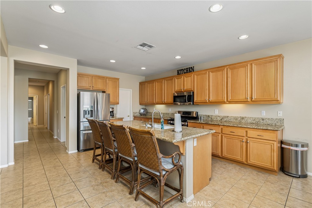 49267 Biery Street Indio, CA 92201 - Photo 7 of 28 a kitchen with stainless steel appliances granite countertop a table and chairs
