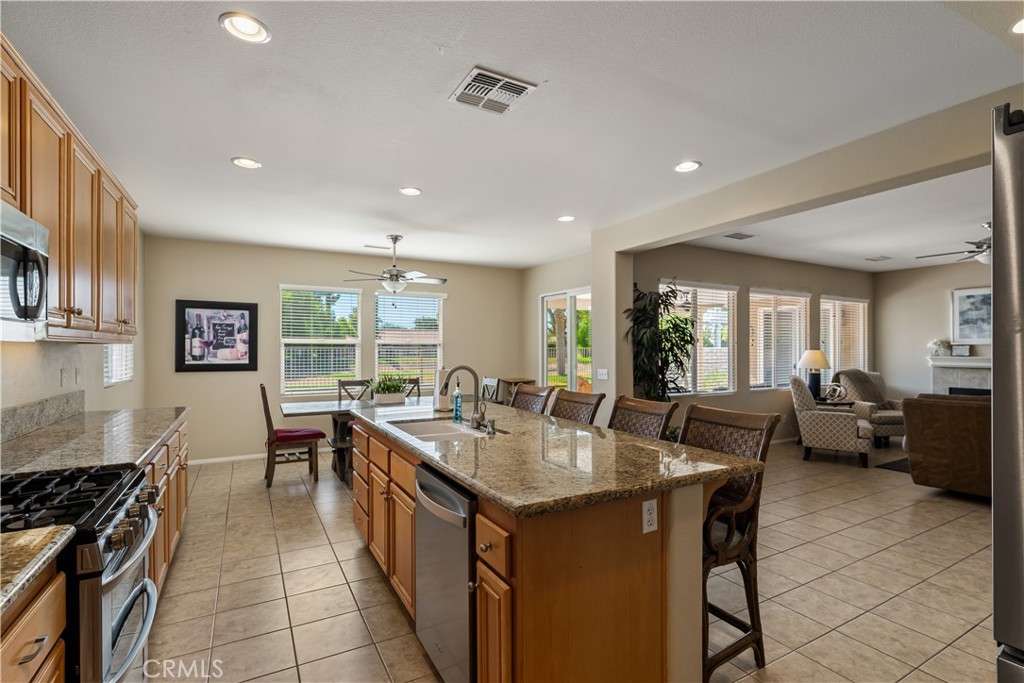 49267 Biery Street Indio, CA 92201 - Photo 9 of 28 a kitchen with counter top space a sink a stove and wooden floor