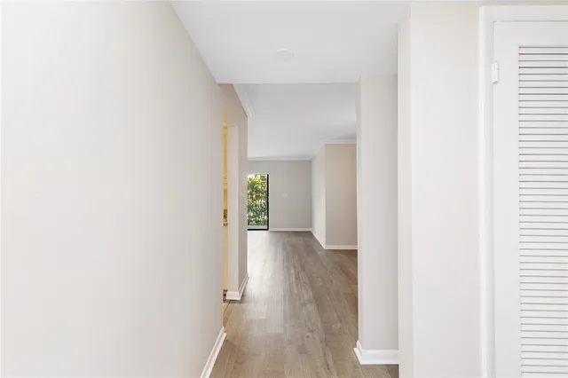 a view of a hallway with wooden floor