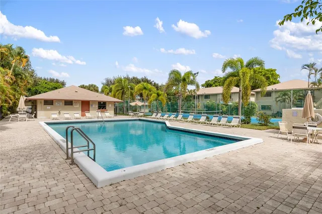 a view of a swimming pool with a lounge chairs