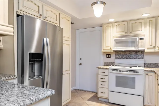 a kitchen with a stove and a refrigerator
