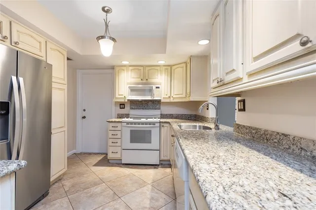 a kitchen with a refrigerator and a sink