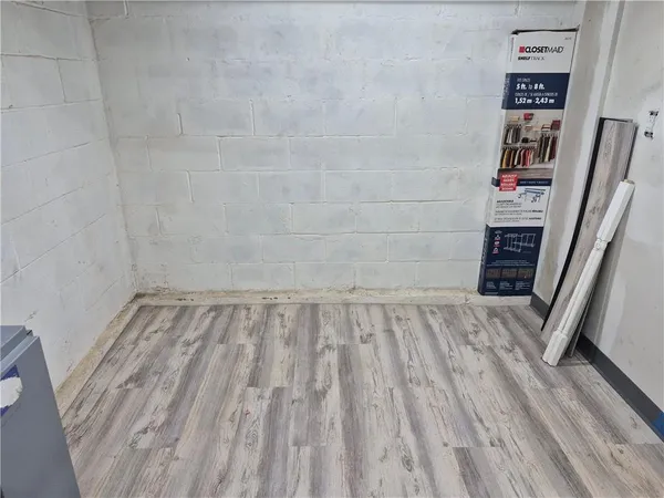 a view of a room with wooden floor and shoes