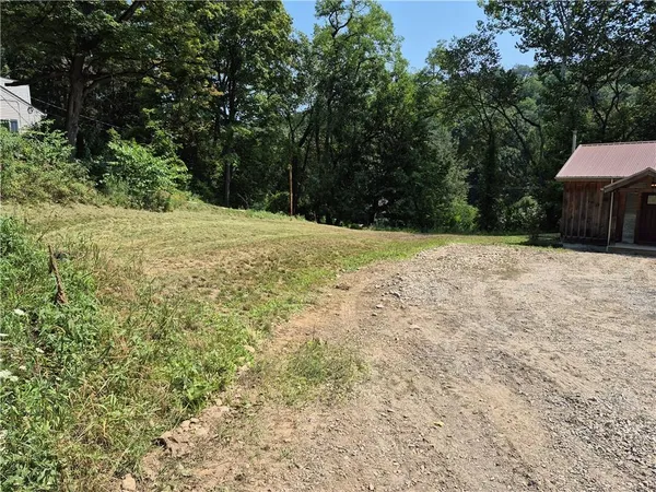 a backyard of a house with large trees