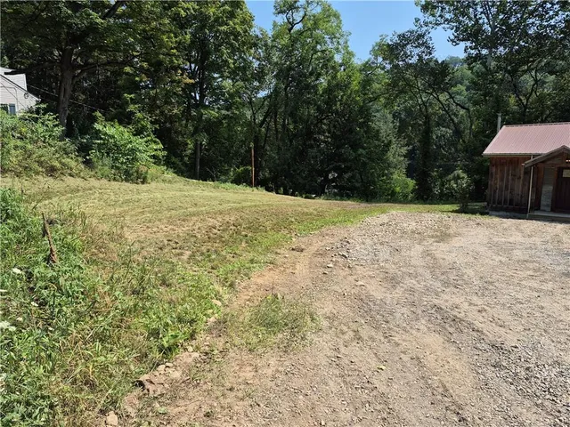 a backyard of a house with large trees