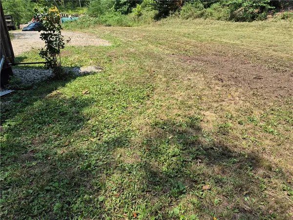 a view of a field with an trees