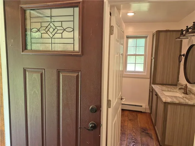 a view of a bathroom with wooden floor and a window
