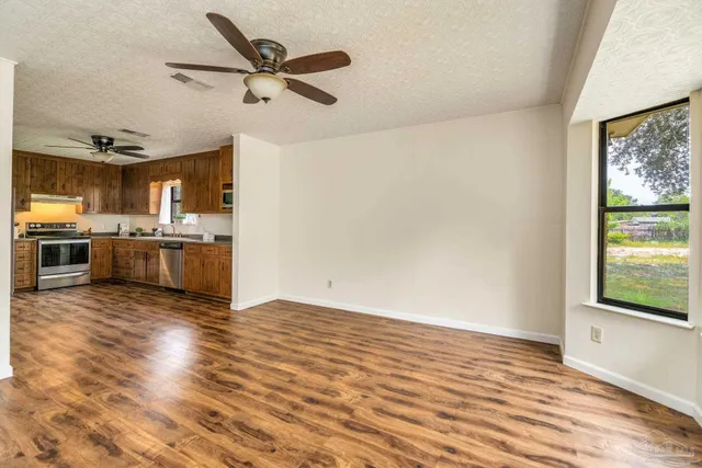 a view of a kitchen with a stove cabinets and wooden floor