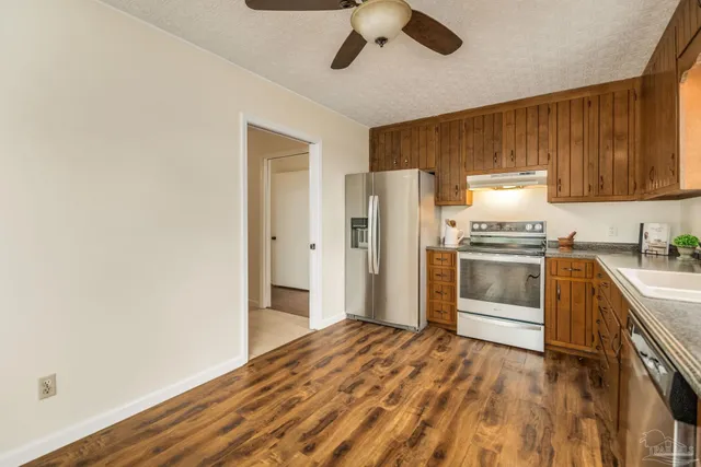 a kitchen with a refrigerator and a sink