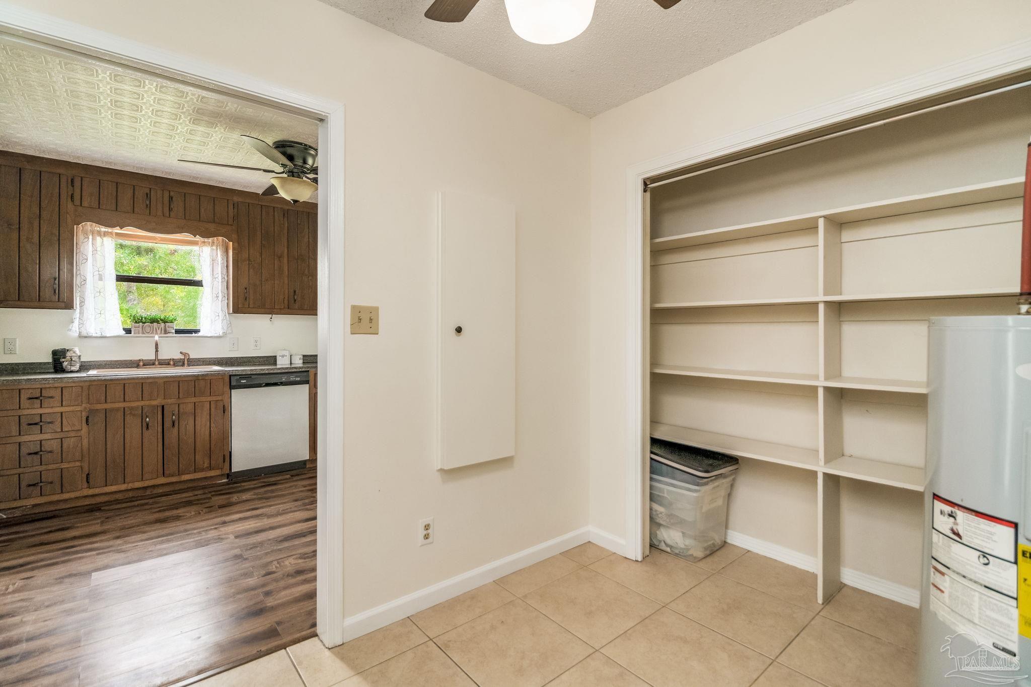 7489 Sandstone Street Navarre, FL 32566 - Photo 15 of 49 a bathroom with a sink a toilet and a window