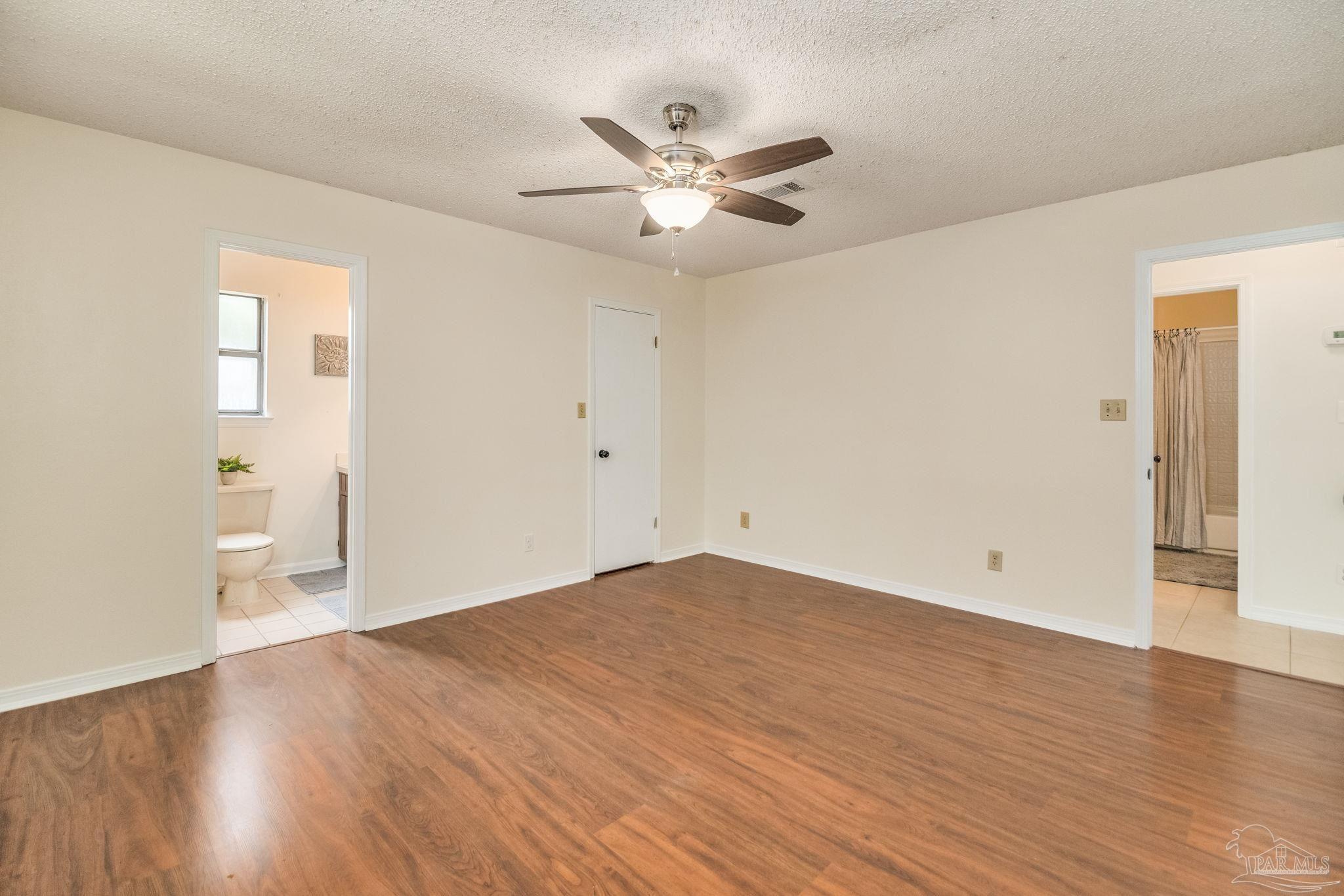 7489 Sandstone Street Navarre, FL 32566 - Photo 20 of 49 a view of a livingroom with a ceiling fan and wooden floor