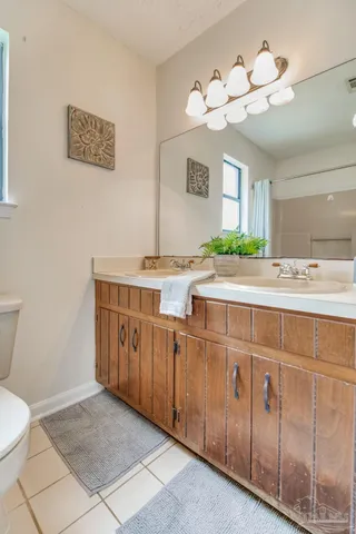 a bathroom with a sink a mirror and a toilet