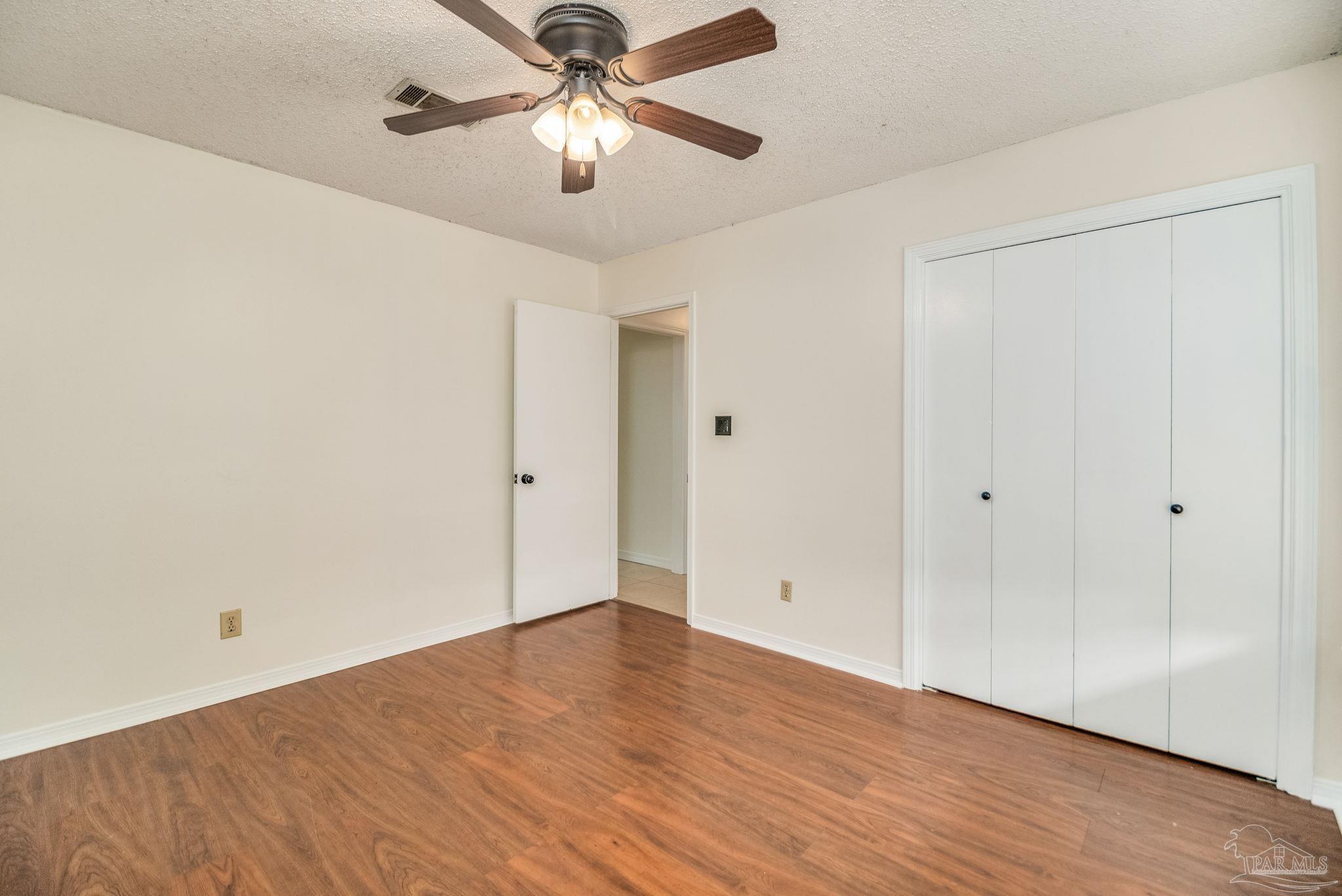 7489 Sandstone Street Navarre, FL 32566 - Photo 26 of 49 wooden floor in an empty room