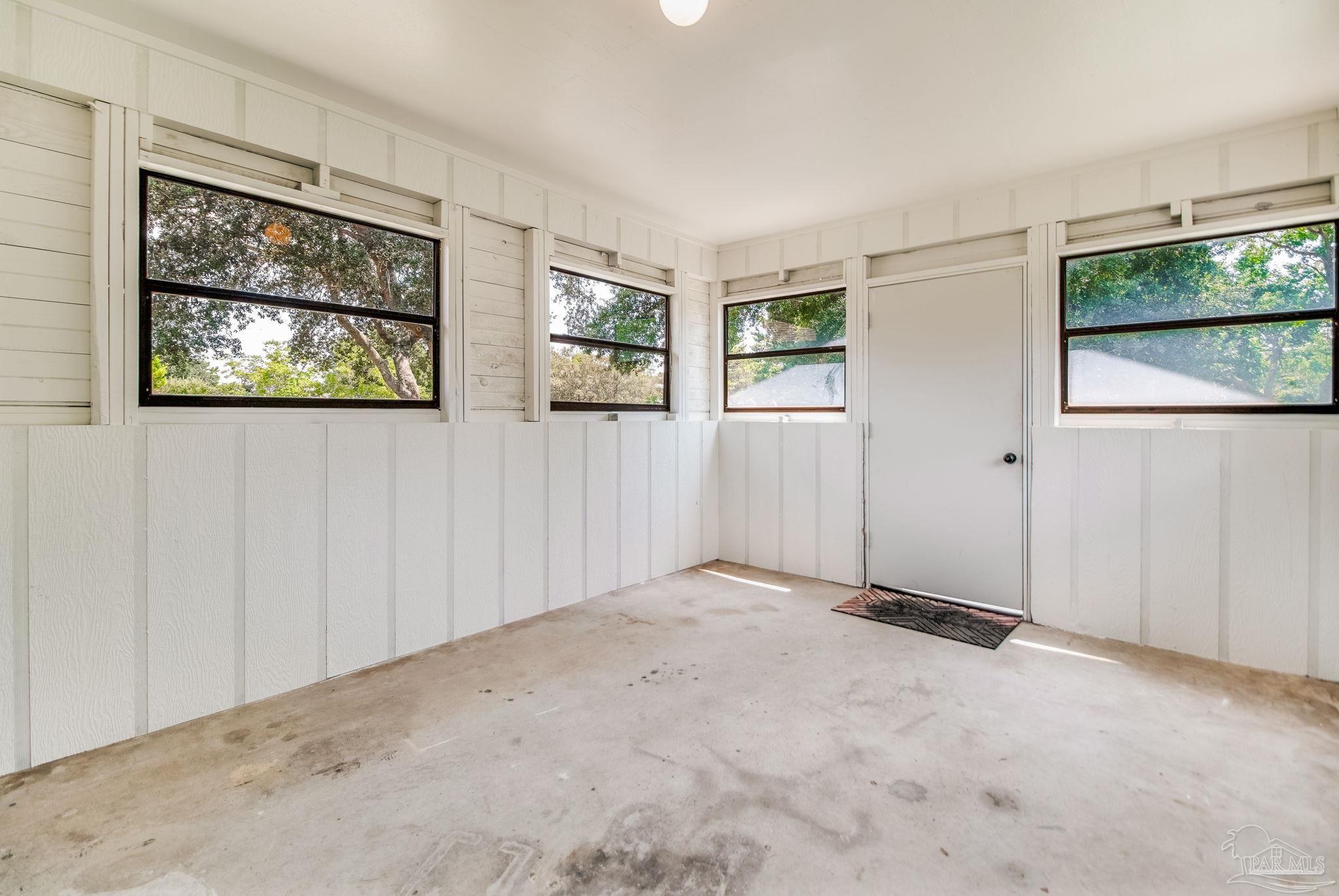 7489 Sandstone Street Navarre, FL 32566 - Photo 31 of 49 an empty room with windows
