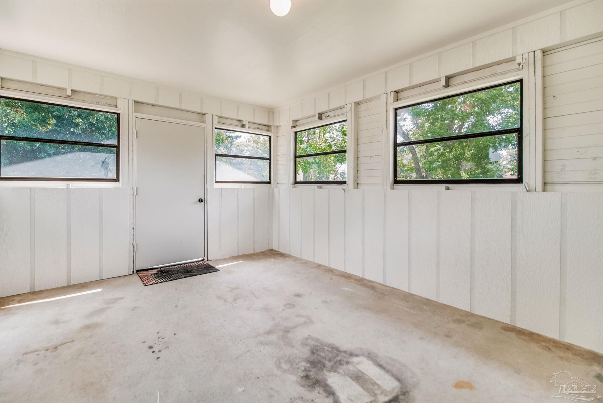 7489 Sandstone Street Navarre, FL 32566 - Photo 32 of 49 an empty room with windows