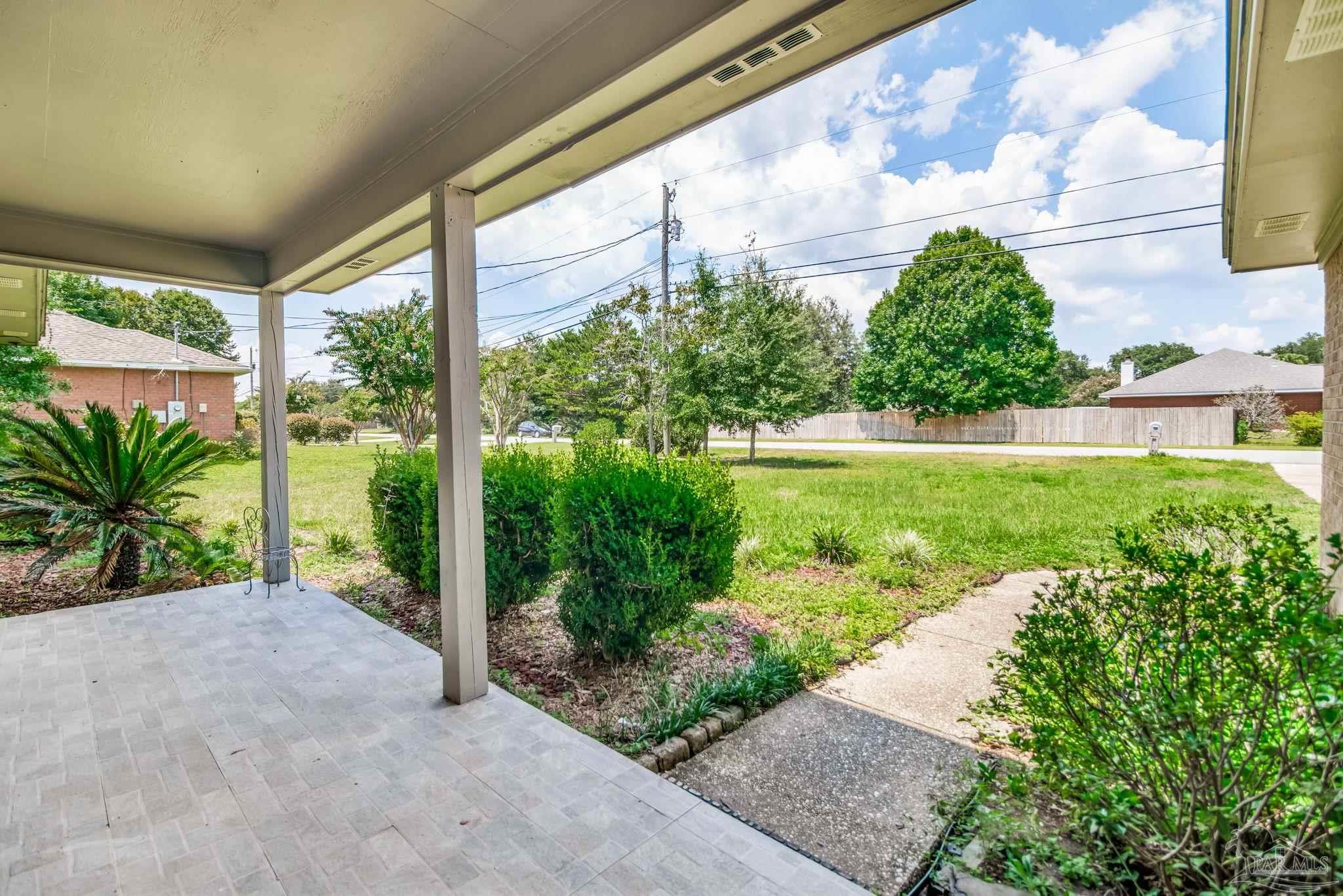 7489 Sandstone Street Navarre, FL 32566 - Photo 36 of 49 a view of a garden with a fountain