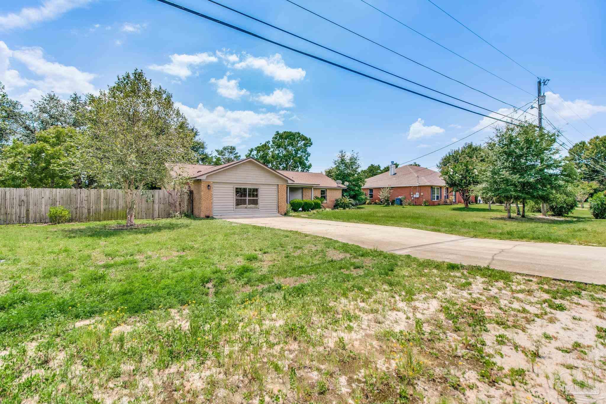 7489 Sandstone Street Navarre, FL 32566 - Photo 37 of 49 a house view with a garden space
