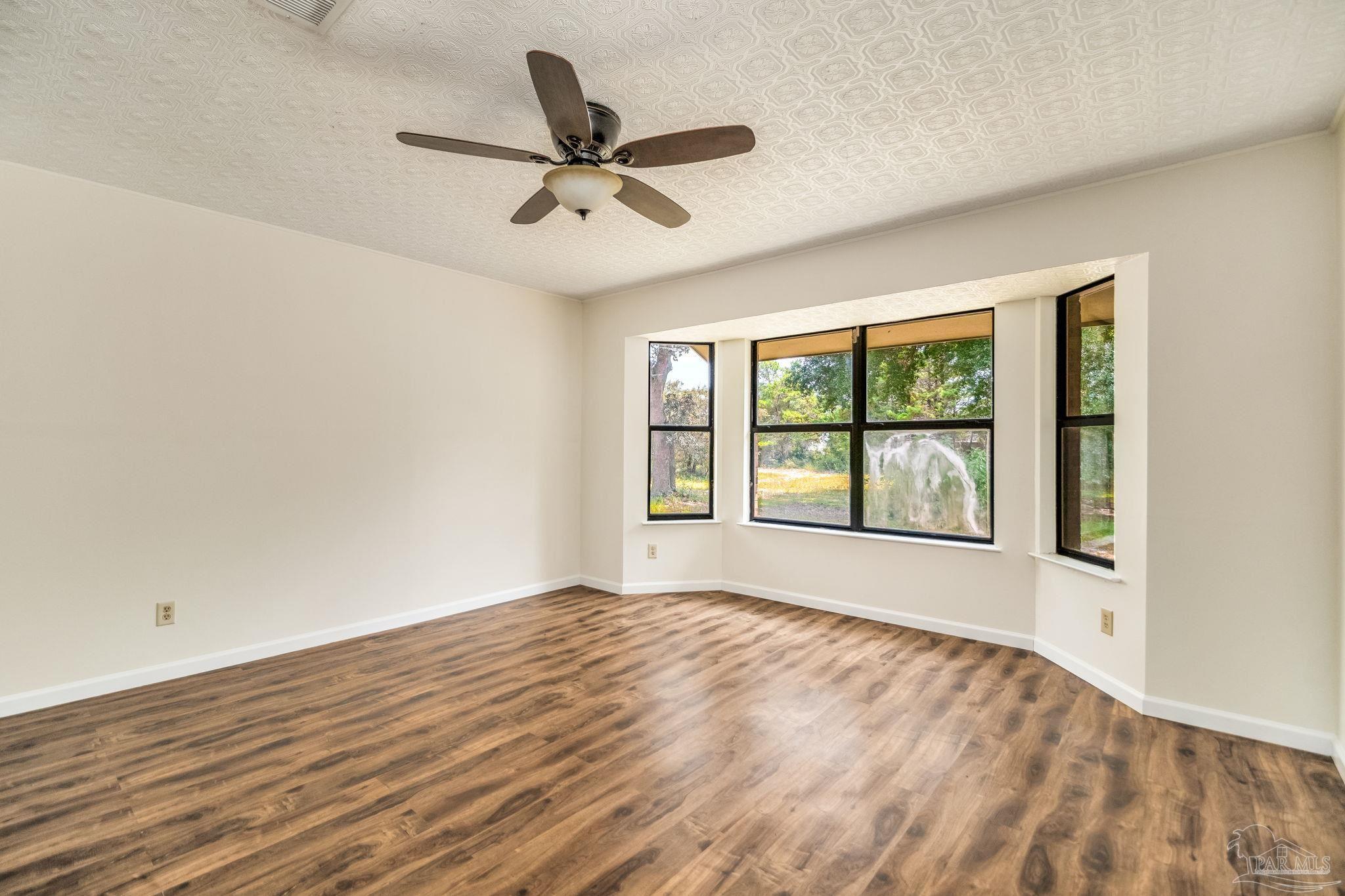 7489 Sandstone Street Navarre, FL 32566 - Photo 9 of 49 a view of an empty room with a window